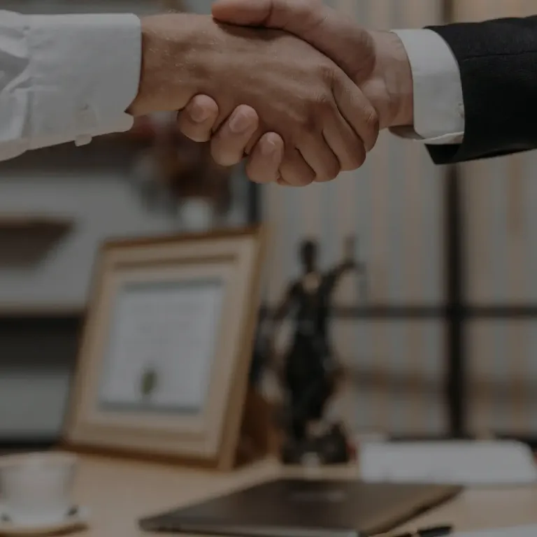 Two businesspeople shaking hands, signifying a successful deal or partnership.