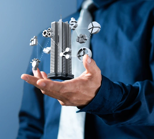 Businessperson holding a 3D model of a building with connected business icons.
