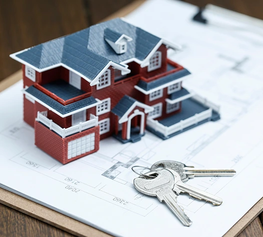 House model on blueprints with keys; home buying, real estate
